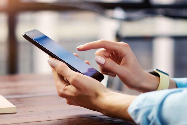 Request Policy Change - Woman Using an iPhone to Request a Policy Change on Her Insurance Policy
