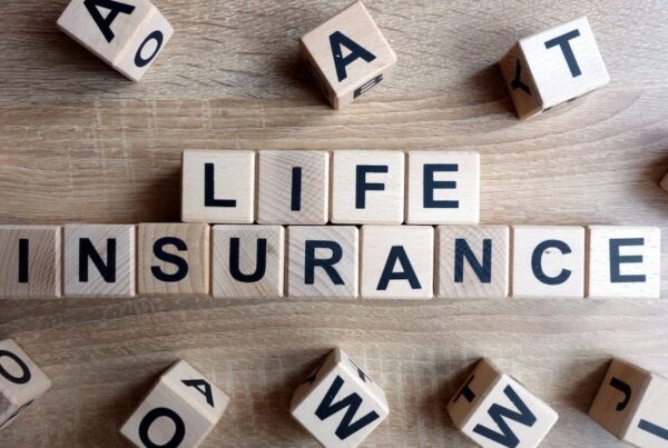 Life Be Life-ing - Life insurance spelled out on a table in blocks