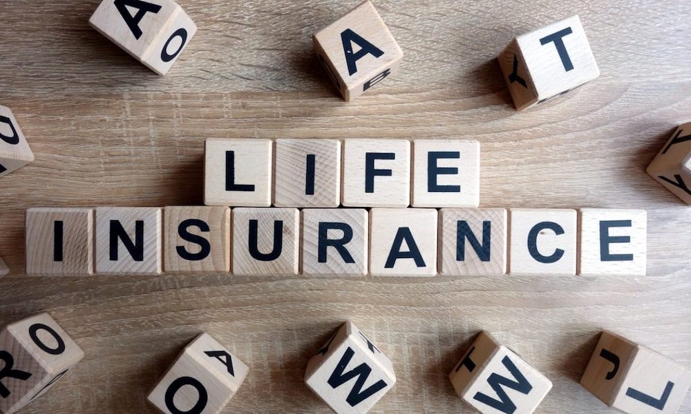 Life Be Life-ing - Life insurance spelled out on a table in blocks